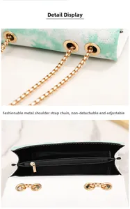 Detail of adjustable gold chain strap and black interior lining on floral shoulder bag