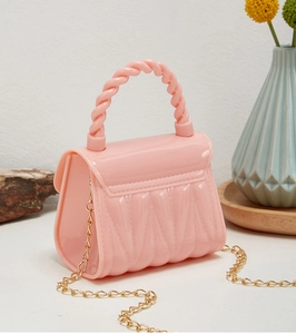 Detailed view of pink silicone mini jelly bag with quilted texture and gold chain strap
