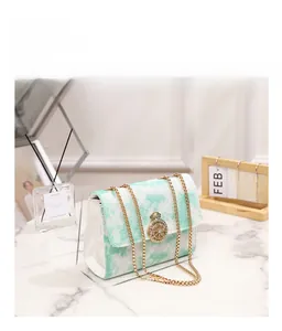 Detailed view of cloud embroidery on green and white quilted chain shoulder bag