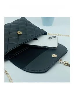 Internal view of black quilted crossbody bag showing storage capacity for a smartphone