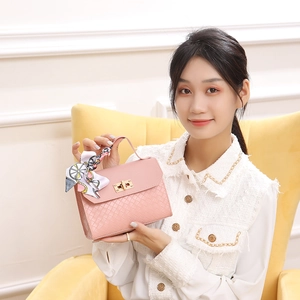 Pink woven texture flap bag with gold lock and floral silk scarf detail on handle