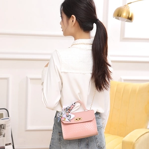 Pink woven leather crossbody bag with silk scarf handle and gold chain strap