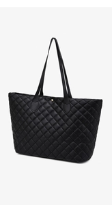 Detail shot of black quilted tote bag showing leather texture and gold magnetic snap button