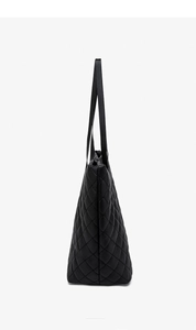 Side view of large black quilted tote bag showing spacious triangular shape and texture