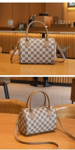Detail view of checkerboard Boston bag with vintage letters and gold-tone zippers