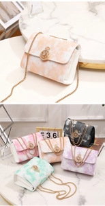 Detail of elegant chain bags with gradient leather texture and golden helm metal buckles
