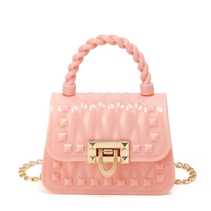 Pink mini jelly bag with rivet texture and gold chain strap on white background