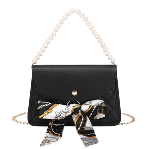 Elegant black quilted leather handbag with pearl handle and floral scarf decoration