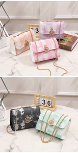 Detail of elegant chain bag featuring gradient dye texture and crown diamond clasp