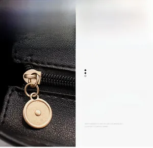 Close-up of durable bronze-gold zipper and premium grainy leather texture on a tote bag