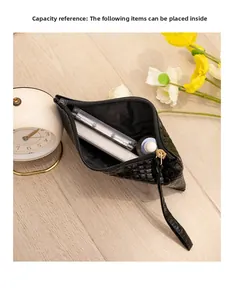 Internal capacity of the crocodile embossed black clutch bag with wrist strap