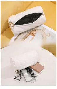 Detail view of white quilted barrel bag showing spacious interior and storage capacity