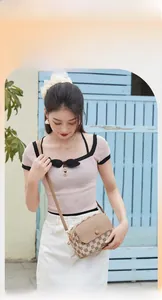 Outdoor lifestyle shot of a retro crossbody shell bag with HORHE logo and patterns
