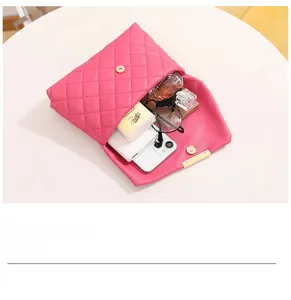 Pink quilted leather bag showing interior storage capacity for phone and perfume