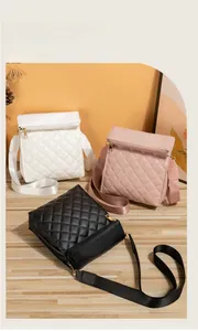 Three quilted crossbody bags in white, pink, and black colors with adjustable straps
