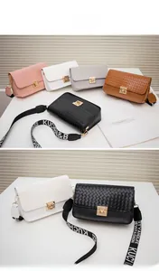 Collection of woven crossbody bags in five colors with wide jacquard straps and metal locks