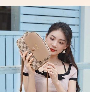 Detail of checkered beige and brown shoulder bag with HORHE logo and thin strap