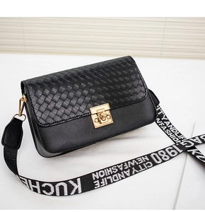 Detail of black woven leather crossbody bag with gold lock and branded fabric strap