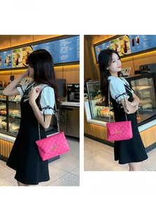 Detail of pink quilted shoulder bag with gold chain strap and elegant metal clasp