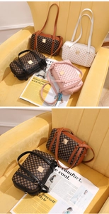 Detail view of stylish patterned square bags on velvet surface with zipper closure