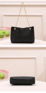 Detailed view of black quilted bucket bag with golden chain strap and refined stitching