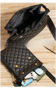 Internal view of black quilted crossbody bag showing spacious capacity for phone and wallet