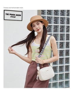 Detailed view of the white embossed texture on a chic women's camera crossbody bag