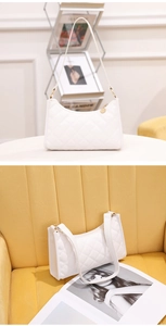 Close-up of white quilted leather hobo bag with gold hardware and zipper detail