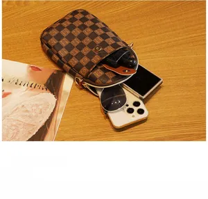 Vertical brown checkered mini bag showing interior space for phone and accessories