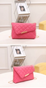 Detail view of pink quilted chain bag with elegant gold-tone metal clasp and hardware