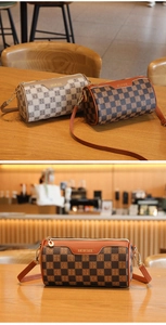 Makroaufnahme von Vintage-Zylindertaschen mit Monogramm-Schachbrettmuster auf einem Tisch