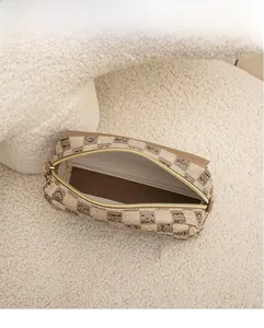 Top view of retro checkered shell bag interior with horse crest print and zipper