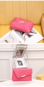 Close-up of fuchsia quilted crossbody bag with gold chain strap and metal trim details