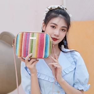 Rainbow woven crossbody bag with colorful stripes and slim pink leather strap