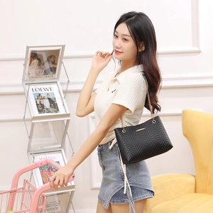 Women's black quilted leather bucket bag with gold chain strap for daily commute