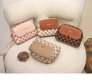 Detailed view of four plaid shell bags in pink, brown, coffee, and beige on white wool texture
