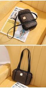 Detailed close-up of retro brown monogram texture and black trim on a square handbag