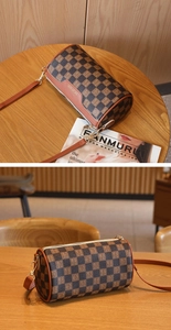 Detail of checkered barrel bag with brand logo and brown leather shoulder strap