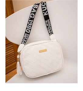 Detail of white textured leather crossbody bag with wide logo strap and gold hardware