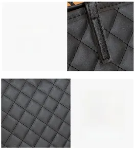 Détail de cuir synthétique matelassé noir montrant des coutures serrées et une texture douce