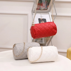 Minimalist quilted cylinder crossbody bags with gold chain straps in red, grey, and white
