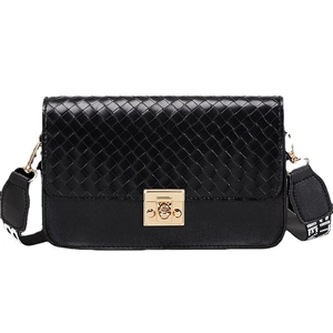 Minimalist black woven flap crossbody bag with a gold buckle and pattern strap