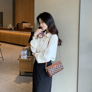 Classic brown checkered cylinder shoulder bag for women styled with white casual shirt