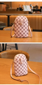 Detailed close-up of pink checkered mini bag with letter pattern and round button closure