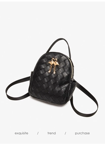 Detailed view of black quilted mini backpack with a gold swan charm and rhinestone pendant