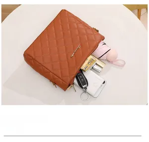 Top view of brown quilted crossbody bag showing spacious interior with daily essentials