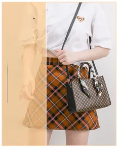 Woman carrying a vintage monogram crossbody bag with silk scarf on the handle