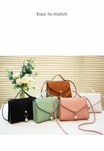 Detail of woven texture shoulder bags with pearl pendants in five various colors