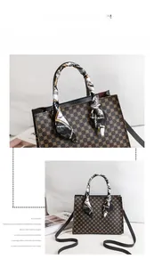 Detail of printed handbag featuring silk scarf handle and detachable shoulder strap