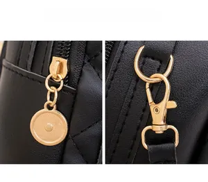 Detail of high-quality gold hardware and quilted black leather on a fashion backpack